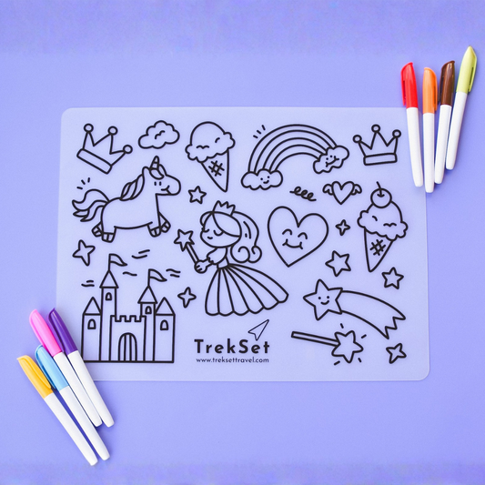 Coloring sheet with fairy, unicorn, castle, and other illustrations on a purple background with markers.